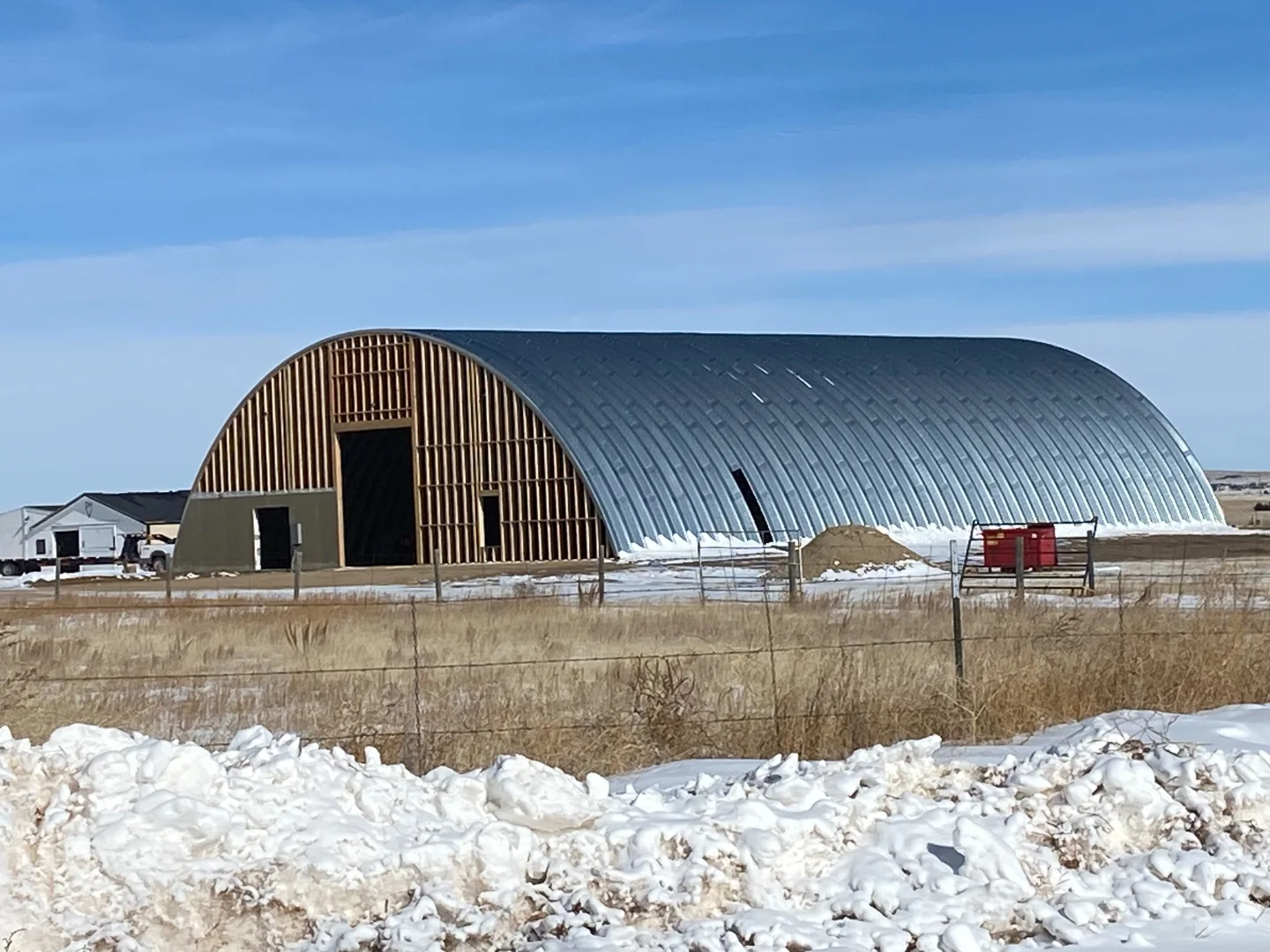 Q Series rounded-arch steel building with a tall framed opening