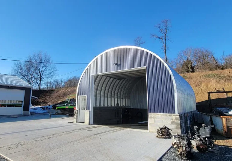 S Series steel building with straight sidewalls, a curved roof and an open front bay